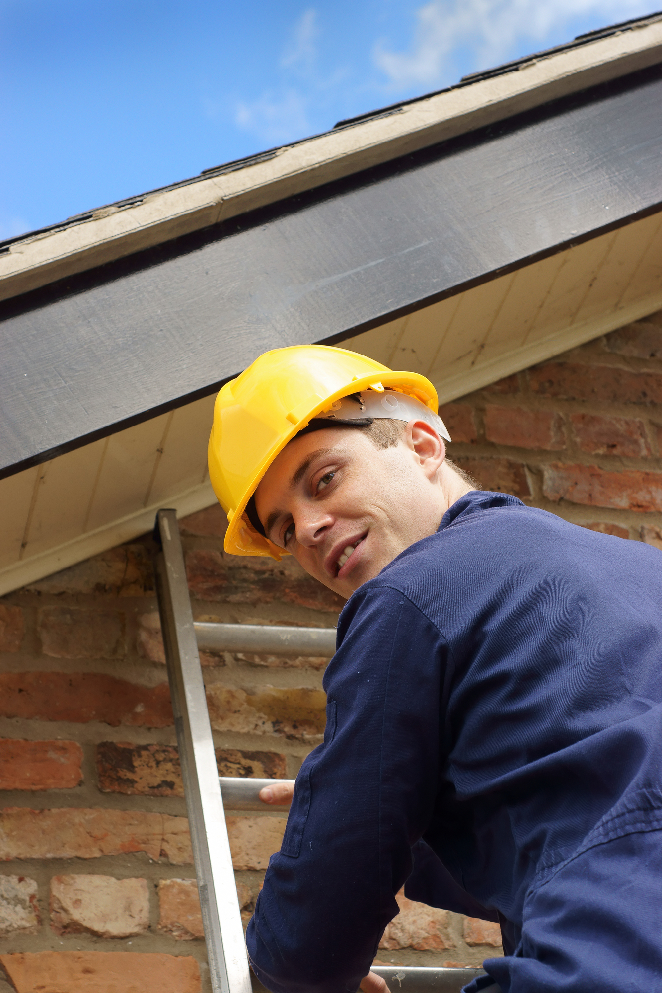 Builder or roofer climbing a ladder