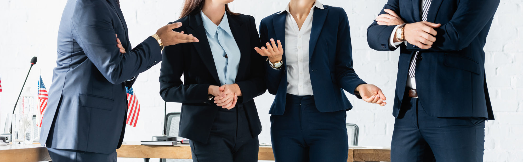 Multicultural politicians gesturing while standing in boardroom